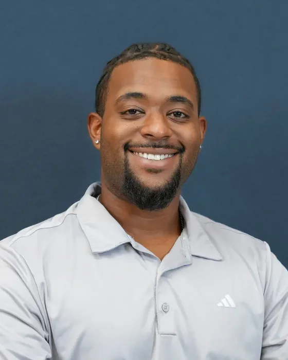 Studio headshot, male subject, grey polo