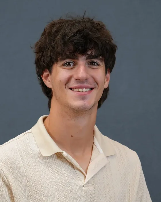 Studio headshot, male subject, cream sweater