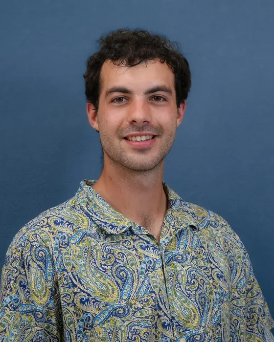 Studio headshot, male subject, patterned shirt