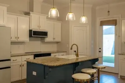 Kitchen — Navy island and brass pendants
